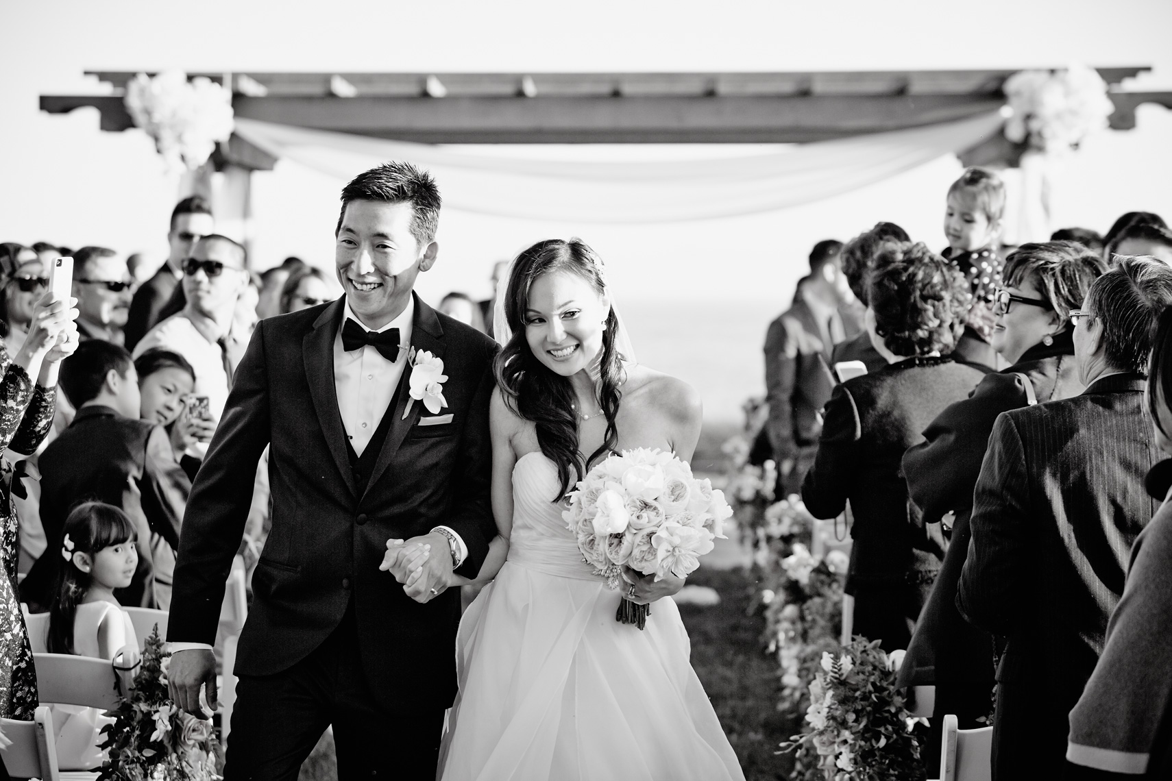 Bride and groom walk down the aisle after getting married at Terranea Resort in Rancho Palos Verdes, California.